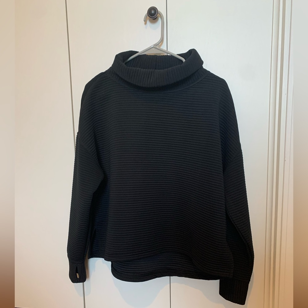 Essential black ribbed sweater.